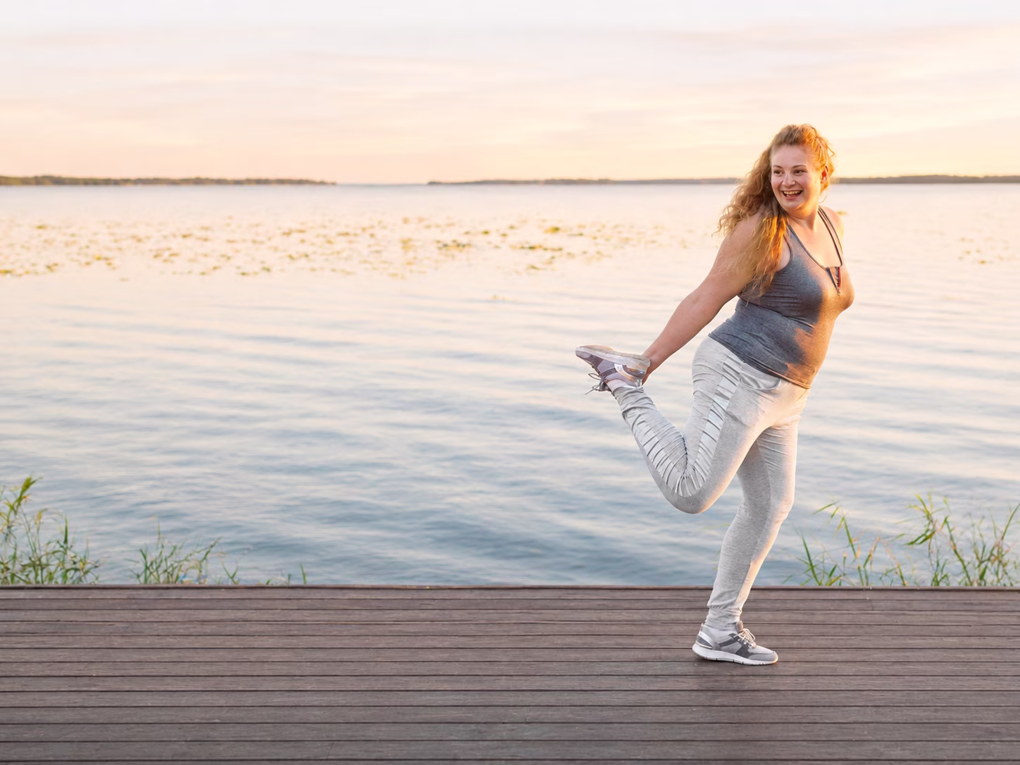 Woman working out by a lake